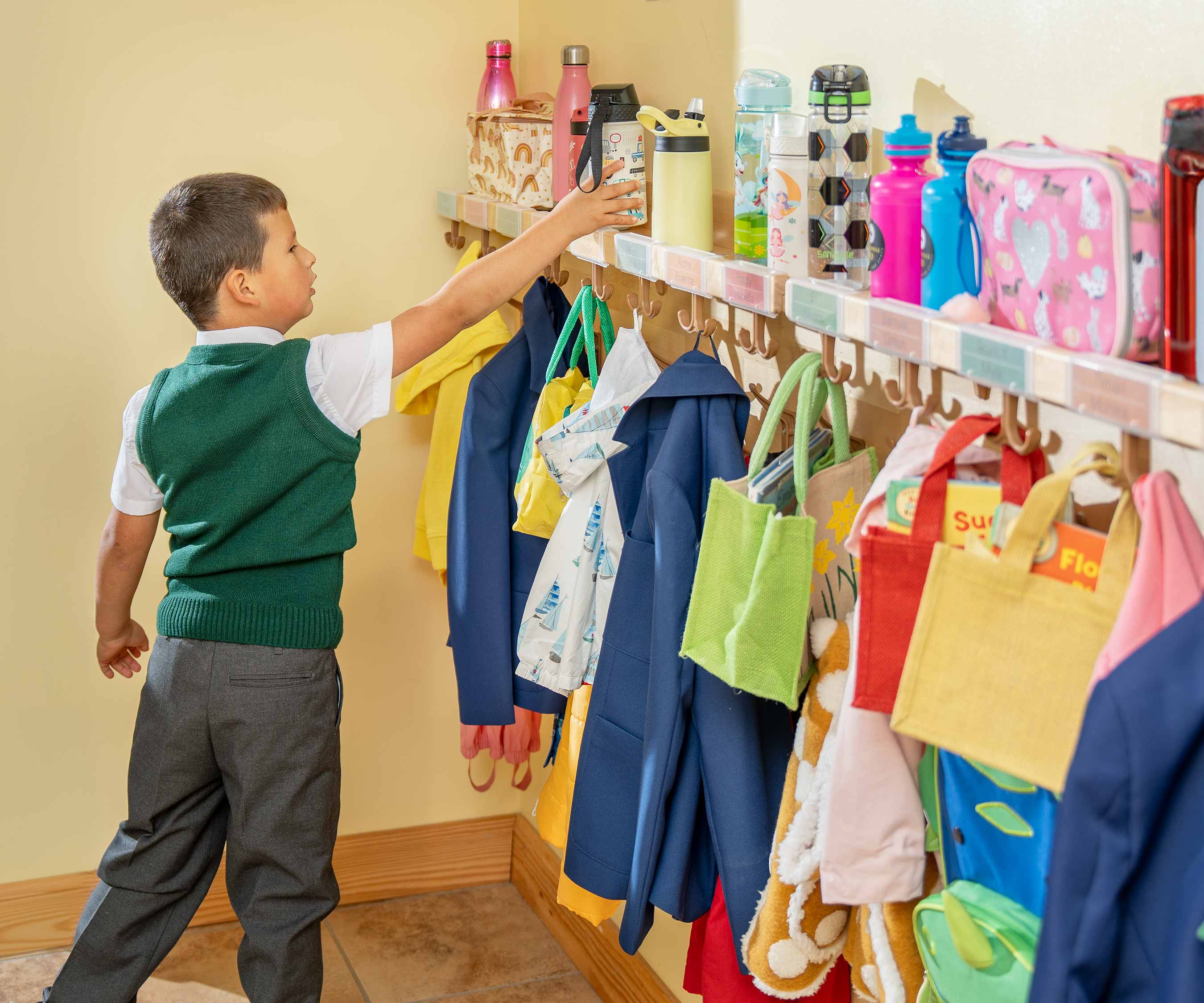 a child using space saving coathooks