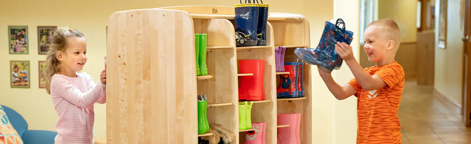 children packing wellies onto the welly storage unit