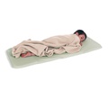 A child snuggled in a beige blanket and resting on a sleep mat