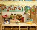 solid wood shelf in a role play corner set up with play materials for children