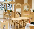 A role play area in a classroom set up with solid wood furniture