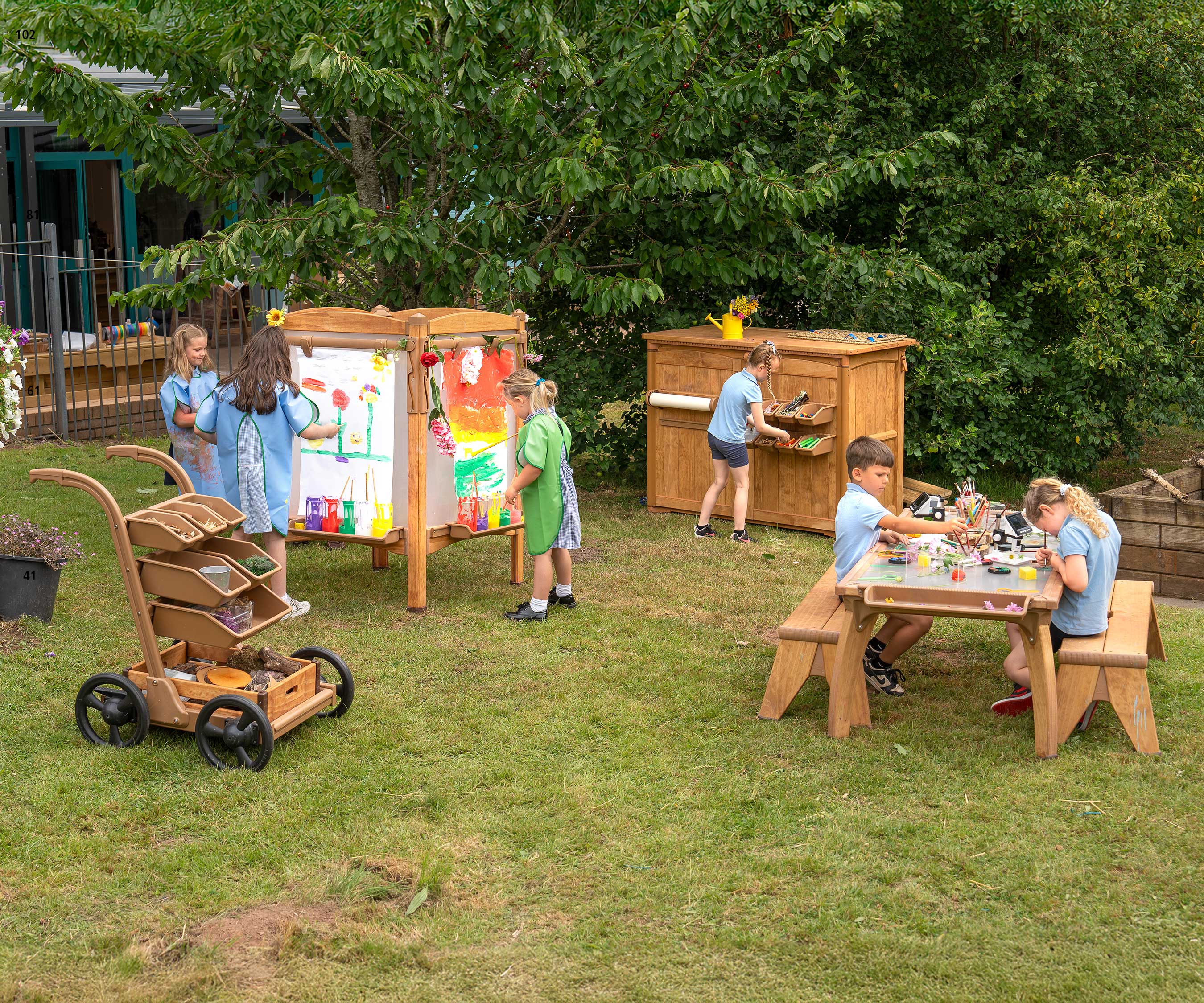 An outdoor science and art classroom at a primary school. The settup included and outdoor easel, table, trolley and art shed.
