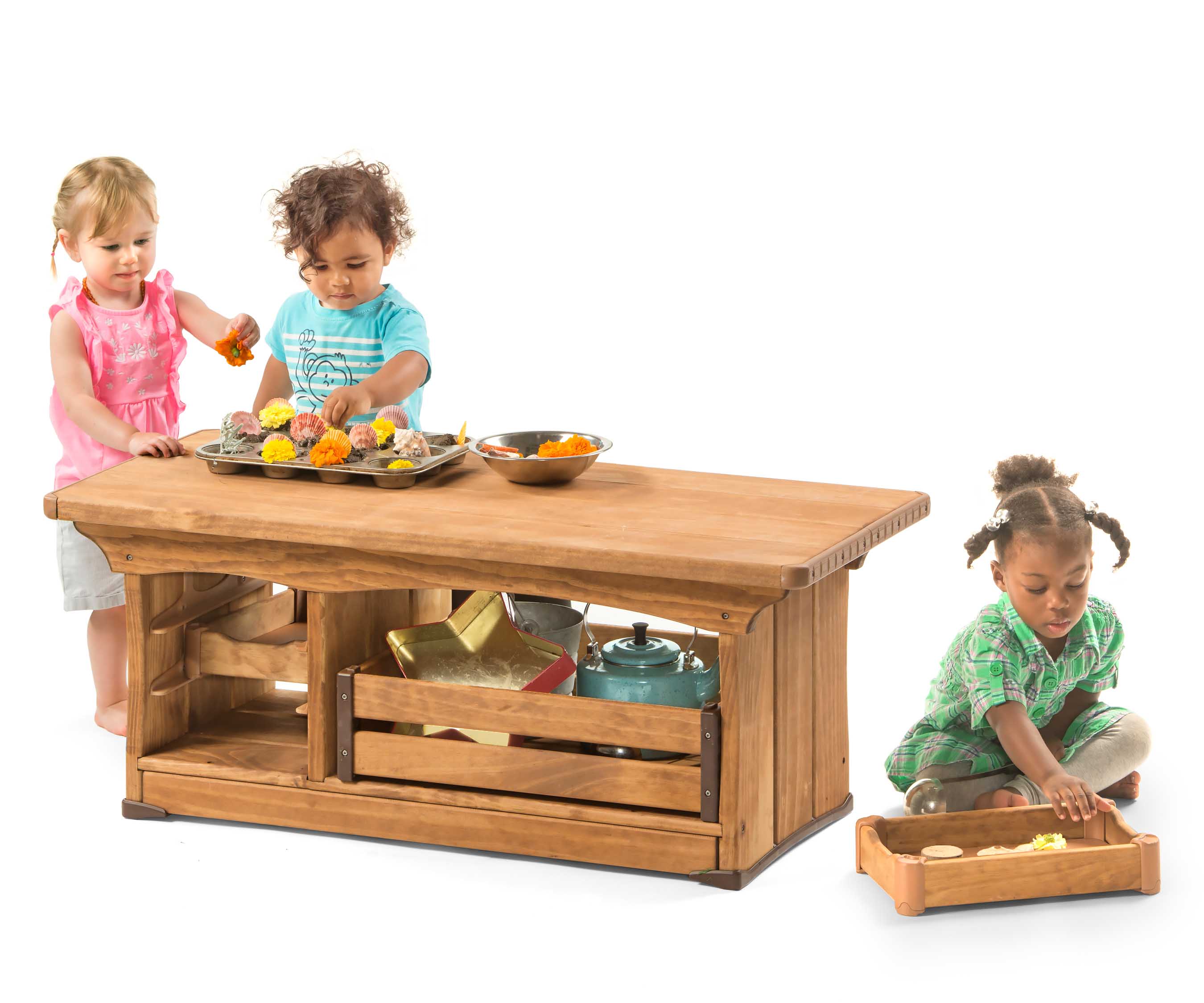 Three toddlers play with an Outlast kitchenette counter