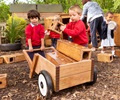 Children loading and hauling blocks in an Outlast wheelbarrow