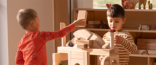 Two boys playing with wooden blocks