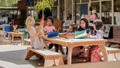 Children sit at an Outlast table