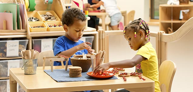 Two children playing in a Community Plaything's Creative Corner.